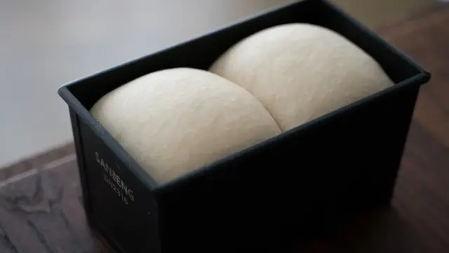 Dough relaxing in a tray during bulk