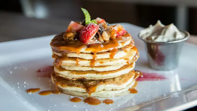 Pancakes topped with fresh fruit on a plate